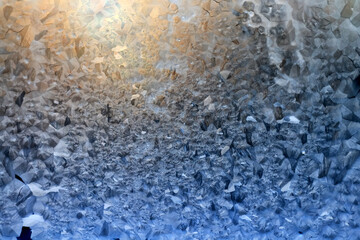 ice pattern on winter glass, abstract background on a cold sunny day