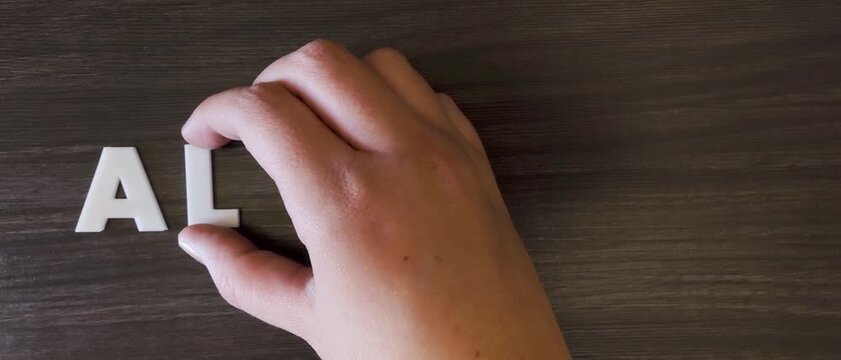 persona escribiendo la palabra alergias en un fondo oscuro con letras blancas y pre hechas