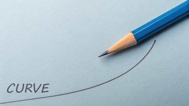 Sharp pencil drawing a curved line on a light blue surface