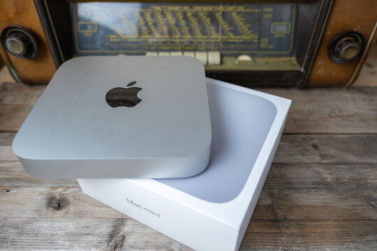 new Apple Mac Mini M1 computer held Unboxing, technology portability, working remotely in cozy home environment, embracing comfortable downshifting lifestyle, Frankfurt - February 4, 2025