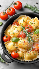 Ravioli in creamy tomato sauce garnished with fresh basil, rosemary, and cherry tomatoes, served in black bowl. dish is sprinkled with grated cheese, creating delicious and inviting meal