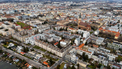 Obraz premium Aerial Drone View of Vienna’s 23rd District Liesing. Modern urban neighborhoods, green parks, quiet residential streets and a panoramic skyline of southern Vienna captured from high altitude