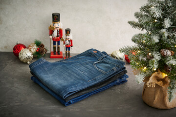A stylish display of various washed denim jeans hanging on a metal grid rack, showcasing different textures, colors, and modern casual fashion details.