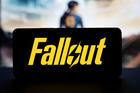 Fallout TV series logo on smartphone screen with blurred character background