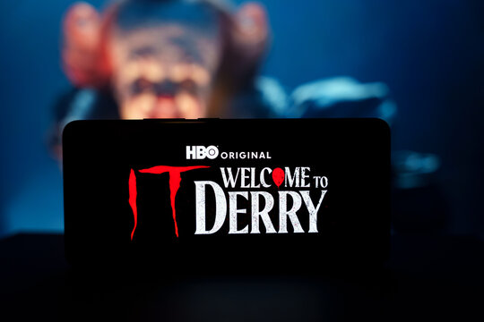 Welcome to Derry HBO series logo on smartphone with clown face background
