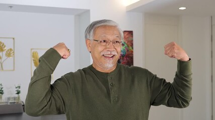 Elderly Man Smiling and Flexing Muscles Indoors