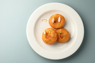 Yummy Badushas served in white ceramic plate top view. Indian dessert