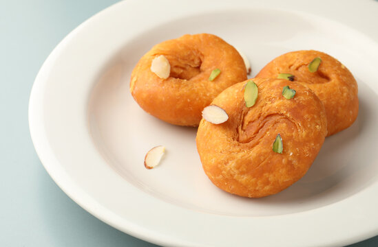 Delicious Badusha served in white ceramic plate. Famous Indian dessert