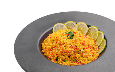Colorful couscous dish with lime and herbs served in a modern bowl