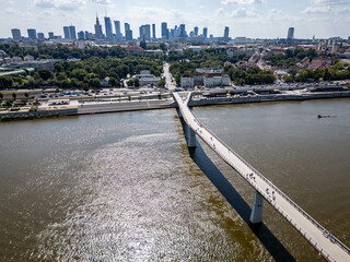 Obraz premium Pedestrian and bicycle footbridge over Vistula River in Warsaw city, Poland