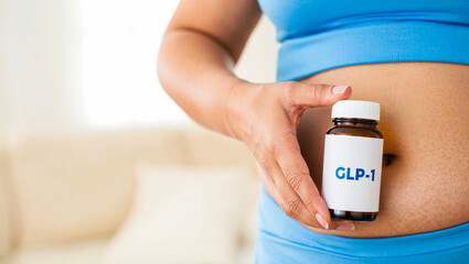 GLP-1 weight loss medication held by person, health and fitness concept, wellness lifestyle, weight loss, healthcare concept, medical treatment, diabetes management, metabolic health research