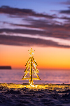 Illuminated Christmas Tree on a beach in summer