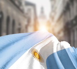 Argentina flag fluttering on blur street with building. Argentina national flag for independence day.