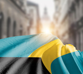 The Bahamas flag fluttering on blur street with building. The Bahamas national flag for independence day.