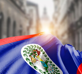 Belize flag fluttering on blur street with building. Belize national flag for independence day.