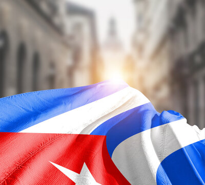 Cuba flag fluttering on blur street with building. Cuba national flag for independence day.