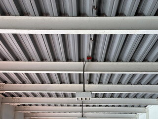Industrial metal ceiling with beams and electrical wiring
