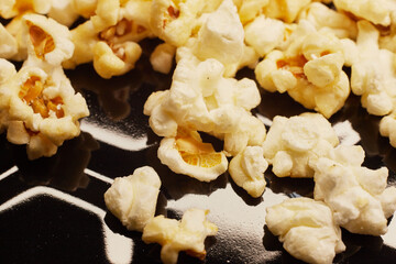 Close-up of fresh popcorn on a black baking tray