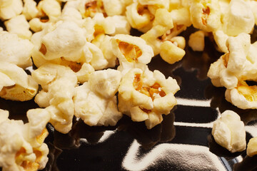 Close-up of fresh popcorn on a black baking tray