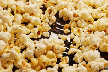 Close-up of fresh popcorn on a black baking tray