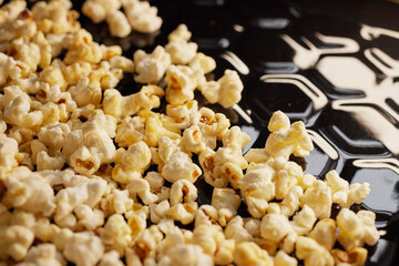 Close-up of fresh popcorn on a black baking tray