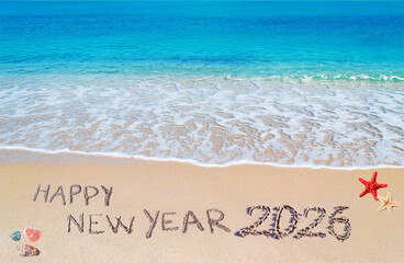 happy new year 2026 written on the shore
