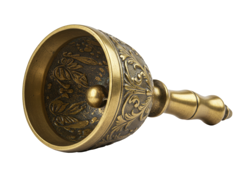 Isolated antique bronze handbell with floral pattern and handle, lying on its side, ready to use