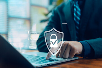 A person entering login information on a laptop with a digital security shield overlay, representing cybersecurity, data protection, password safety, secure access, and online privacy.