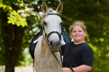 Girl with her horse in nature, a young rider and her equine friend, enjoying the outdoors, equestrian lifestyle, friendship and bonding, summer day, happy child.
