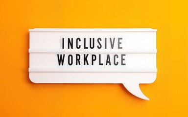 Flat lay composition of speech bubble lightbox with phrase INCLUSIVE WORKPLACE on orange background. High quality