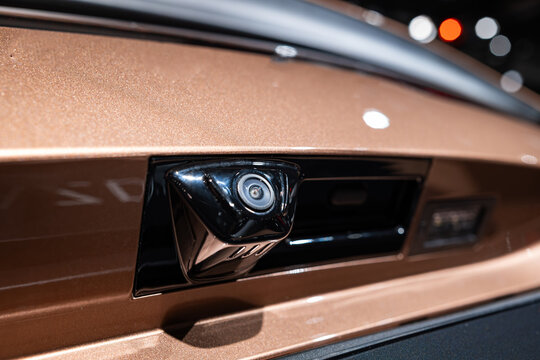 Modern car rear parking assist camera lens unit. Close up shot, no people