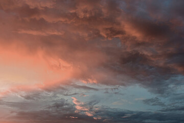 Dreamlike sunset sky glowing softly behind billowing clouds in harmony