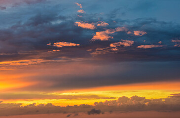 Enchanted sunset sky glowing gently across soft clouds in warm tones