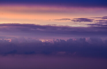 Luminous sky painted by sunset hues, illuminating drifting clouds beautifully