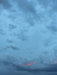 Majestic evening sky lit by warm sunset radiance across cloud textures