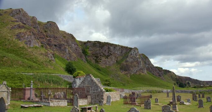 Tilting down shot of Nether kirkyard cemetery burial ground at St. Cyrus, National, Nature, Reserve
