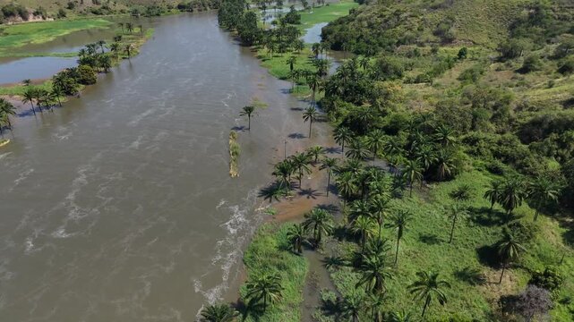 Aerial drone footage of Binga Falls in Angola, showing powerful waterfalls surrounded by lush tropical forest and a scenic bridge over the Kwanza River.