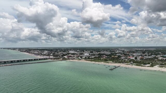 Panoramic aerial view of Progreso, Yucat&aacute;n, on a bright day with large cloud formations over the coast. Drone flyin forward