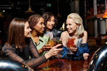 Celebrating friendship and joy at a lively party with cheerful women enjoying cocktails