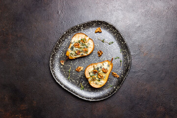 Baked pear with blue cheese, honey, and nuts. Healthy eating. Vegetarian food.