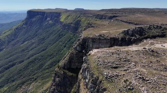 Drone footage over Tundavala Gap, Angola, capturing the rugged cliffs glowing in morning light and the immense drop descending into the valley below