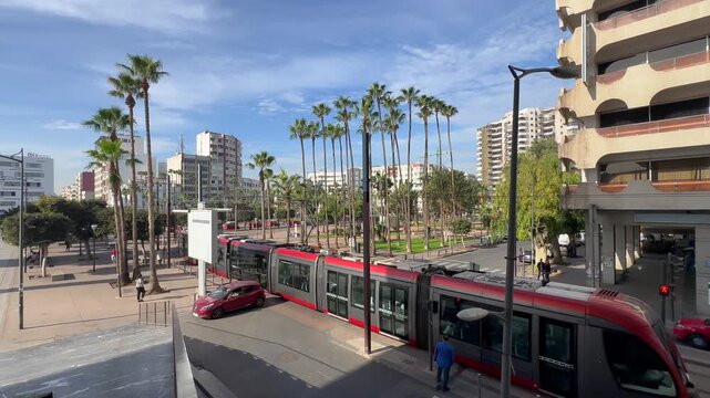 Modern red tramway in downtown Casablanca Morocco, urban public transportation with cars and buildings on a sunny day, African city travel and daily commute Casablanca train station, Morocco. 