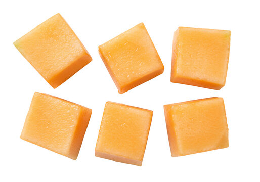 Isolated cubes of cantaloupe, cut and ready to eat, refreshing orange melon pieces