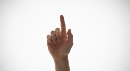 Hand points up with index finger extended against a soft, bright background