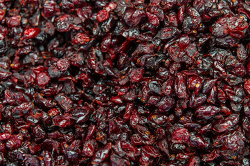 Dried cherries as a background. A top view close-up of dehydrated cherries, ripe berries. The texture of the berries and food as a background