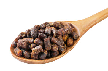 Bee bread in a wooden spoon close-up on a white. Isolated