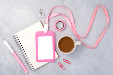 Pink plastic badge with book and coffee on white stone texture background. Template designed for employees of company