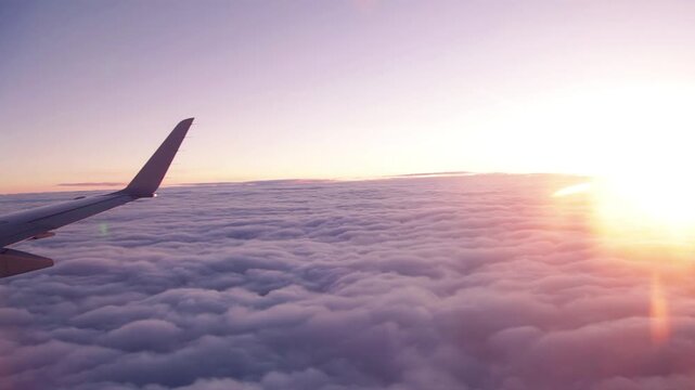 Airplane View above Clouds at Sunset