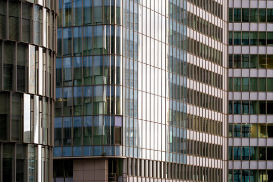 Modern architecture skyscraper facade reflection finance business corporate glass building paris conveying a sleek financial brand aesthetic through clean structural lines