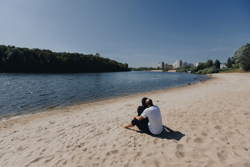 Couple on Sandy Beach by River